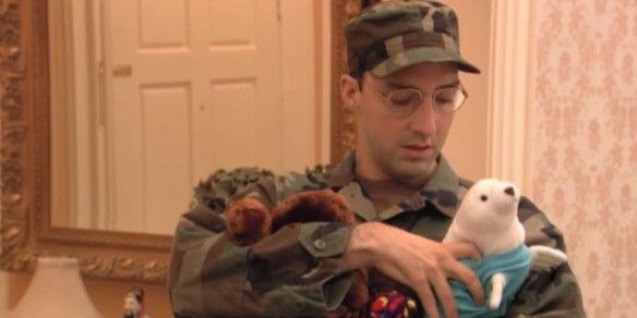 Fotograma de 'Arrested Development': Buster Bluth (Tony Hale) viste un uniforme del ejército y sostiene juguetes de peluche.