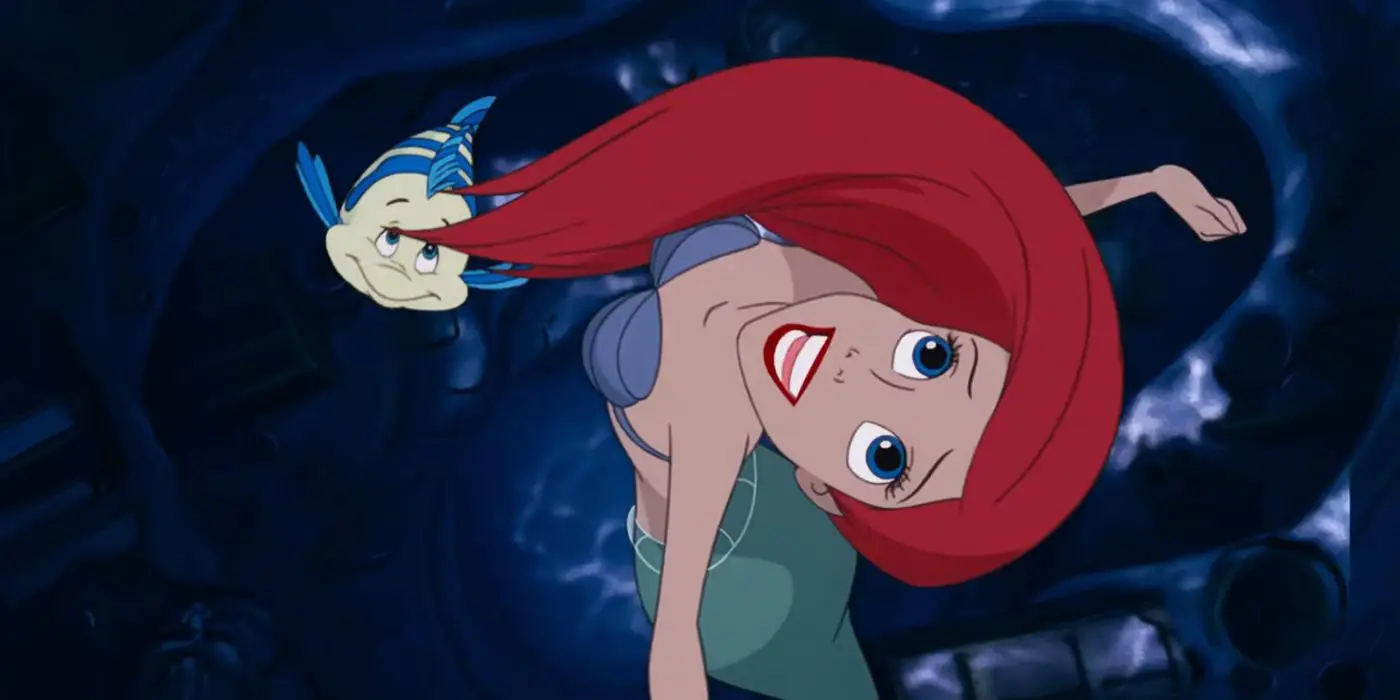 Ariel y Flounder sonríen y nadan mientras miran hacia el cielo en 1989 La Sirenita