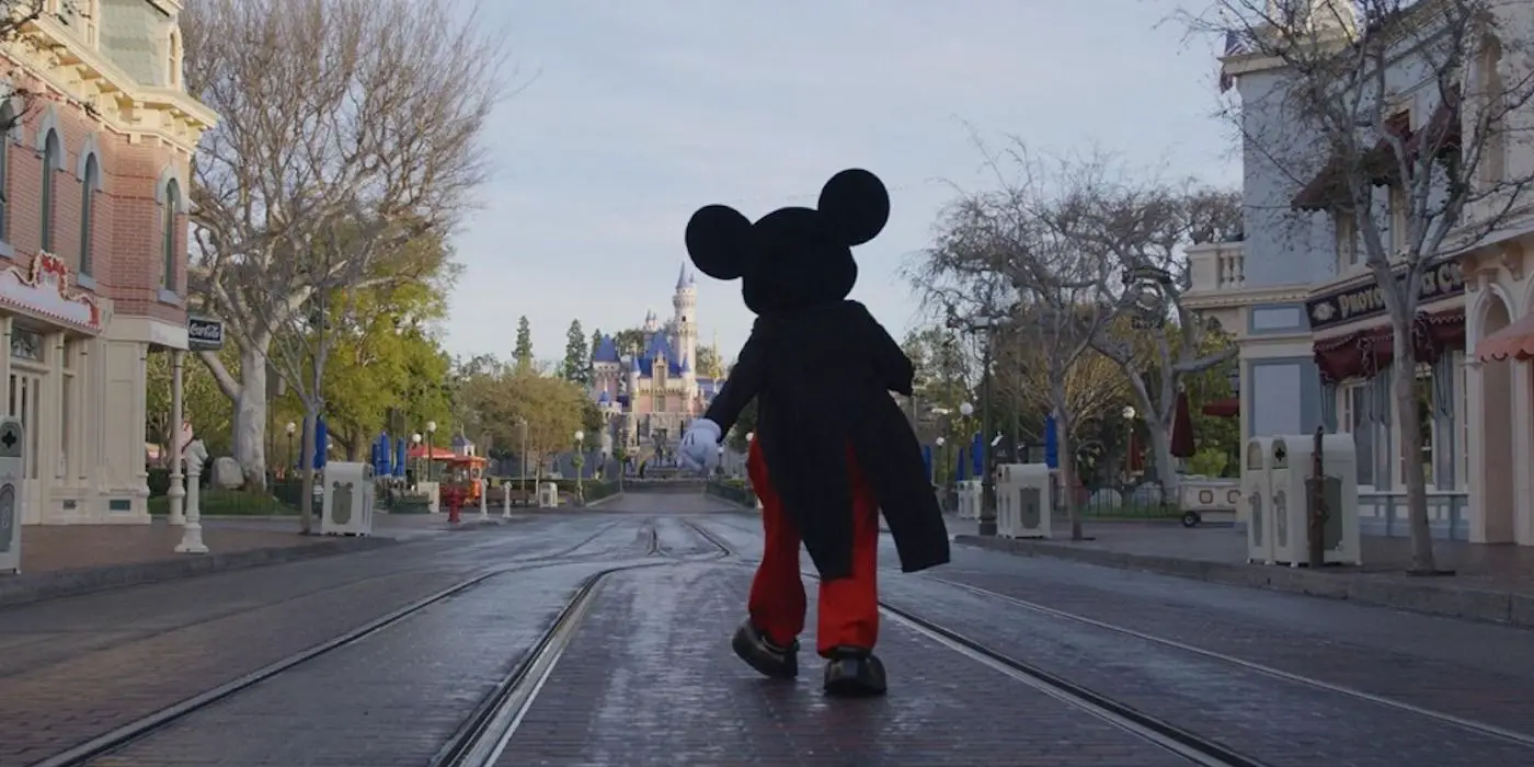 Mickey Mouse caminando hacia el castillo de Disney.