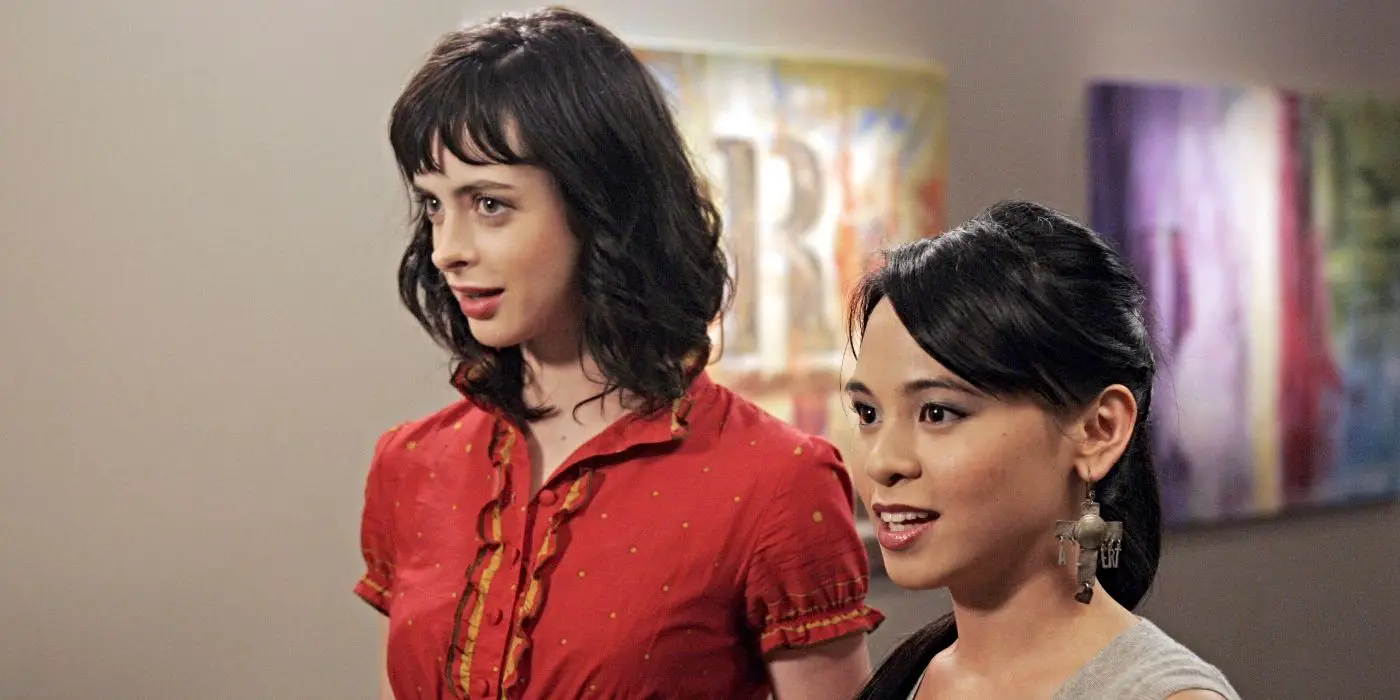 Krysten Ritter y Michelle Ongkingco como Lucy y Olivia, paradas en una exposición de arte y sonriendo a Gilmore Girls